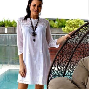 White dress with sheer embroidered sleeves and laced hem